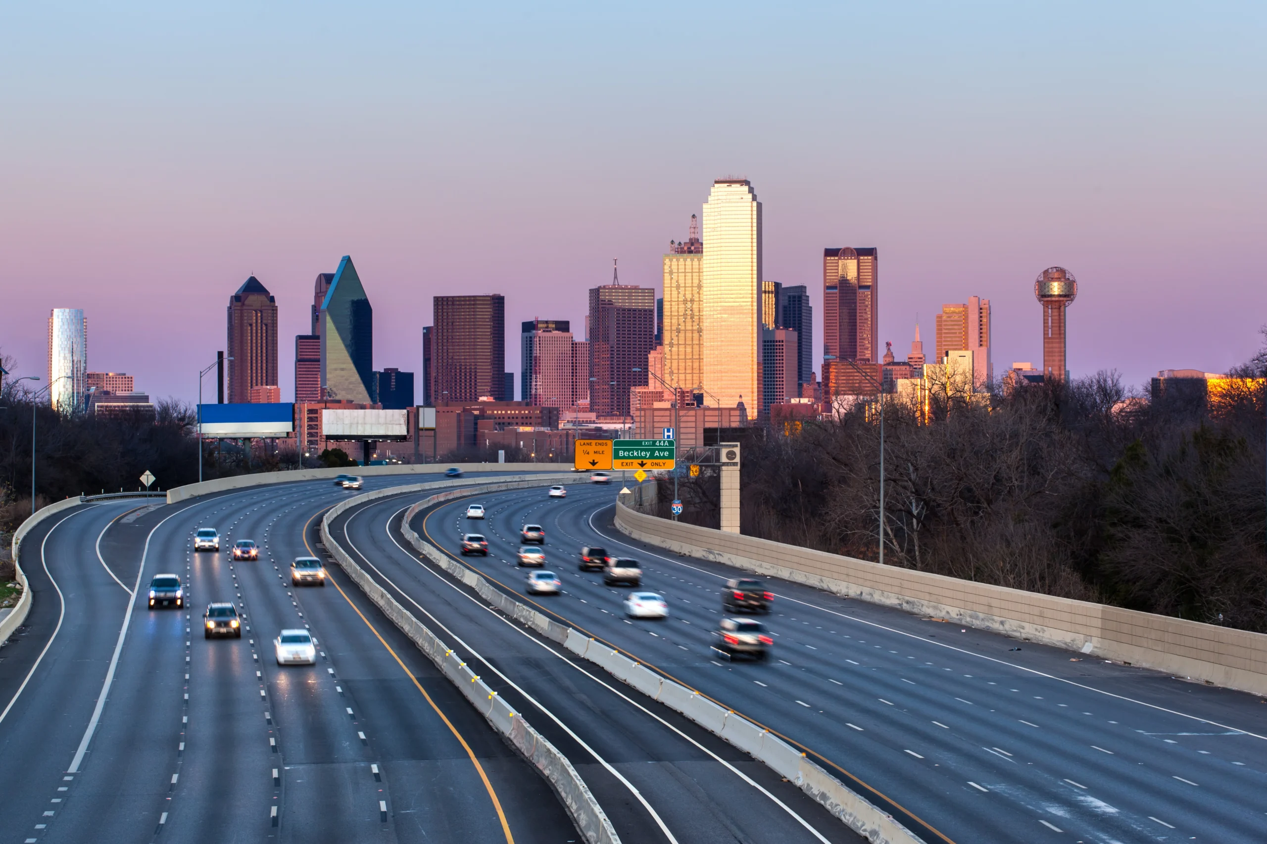 Downtown Dallas skyline over Interstate 30 at sunset, illustrating Mr. Restore’s service area for Dallas water damage restoration.